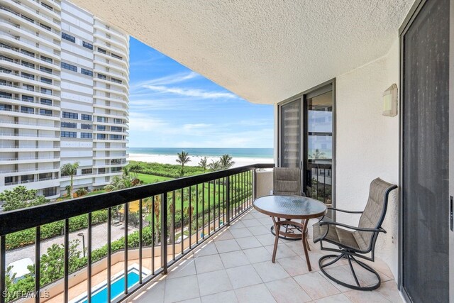 balcony with a swimming pool and a water view