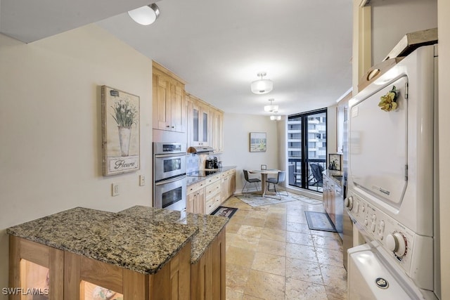 kitchen featuring black electric stovetop, dark stone counters, fridge, light tile patterned floors, and double oven