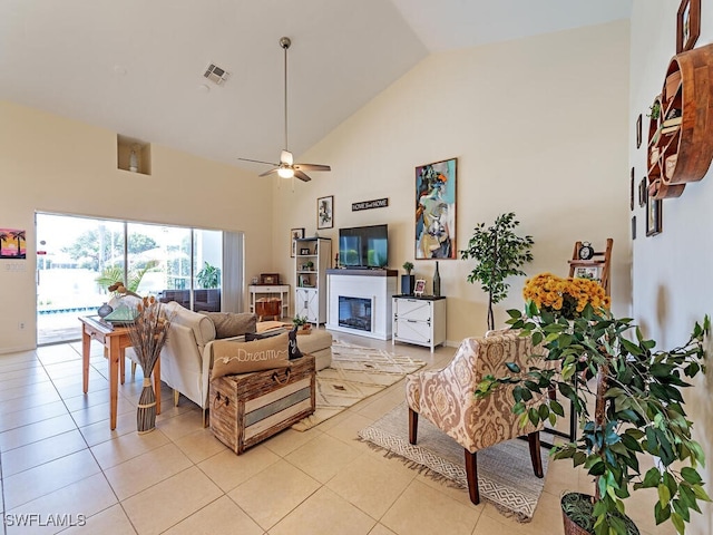 tiled living room featuring high vaulted ceiling and ceiling fan