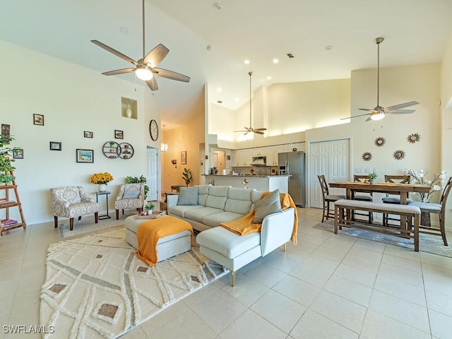 tiled living room featuring high vaulted ceiling and ceiling fan