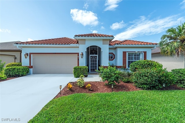 mediterranean / spanish house featuring a garage and a front yard