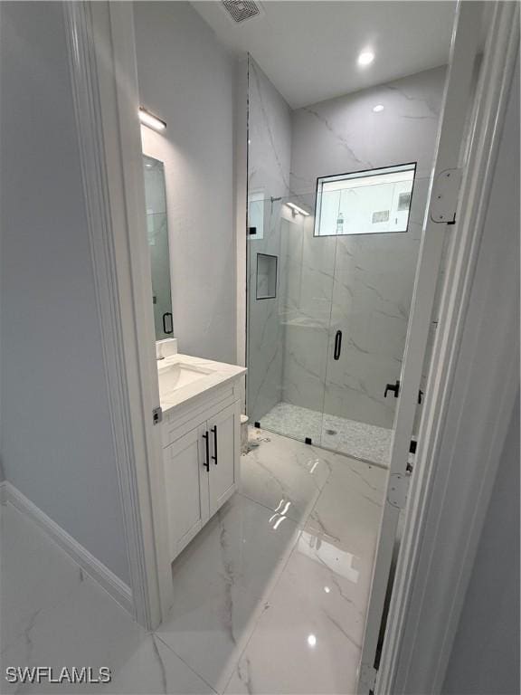 full bathroom with marble finish floor, a marble finish shower, recessed lighting, visible vents, and vanity