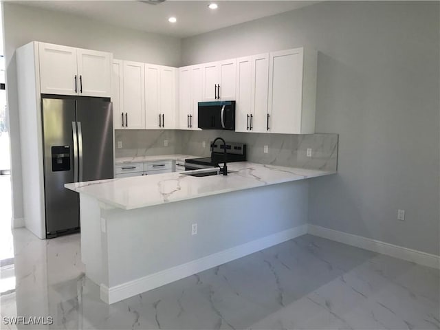 kitchen featuring a peninsula, marble finish floor, stainless steel appliances, white cabinetry, and recessed lighting