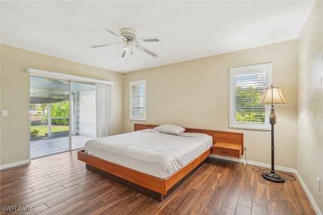 bedroom featuring dark hardwood / wood-style flooring, access to outside, and ceiling fan