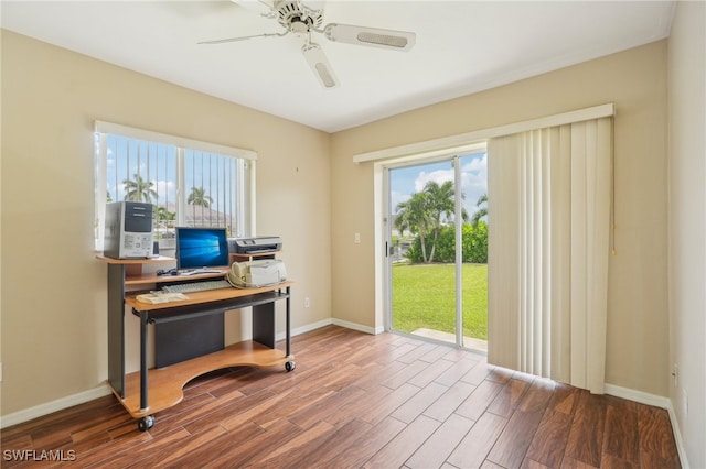 office area with dark wood-type flooring and ceiling fan