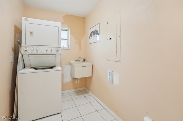 laundry room with stacked washing maching and dryer, electric panel, sink, and light tile patterned floors