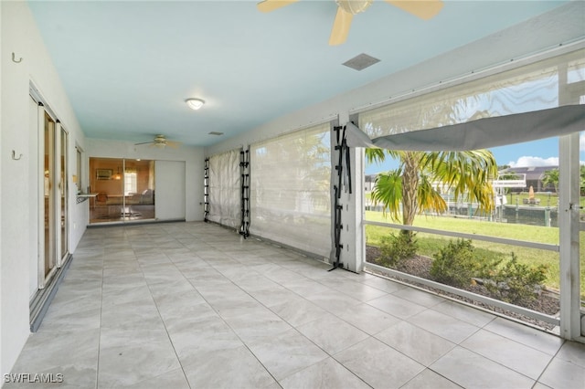 interior space with ceiling fan