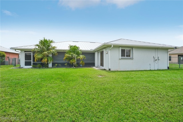 rear view of house with a yard