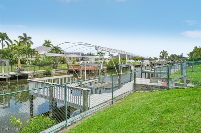 view of dock featuring a yard and a water view