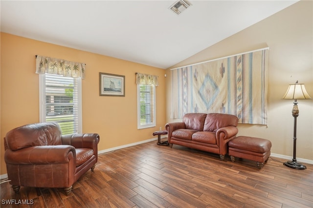 living room featuring lofted ceiling and hardwood / wood-style flooring