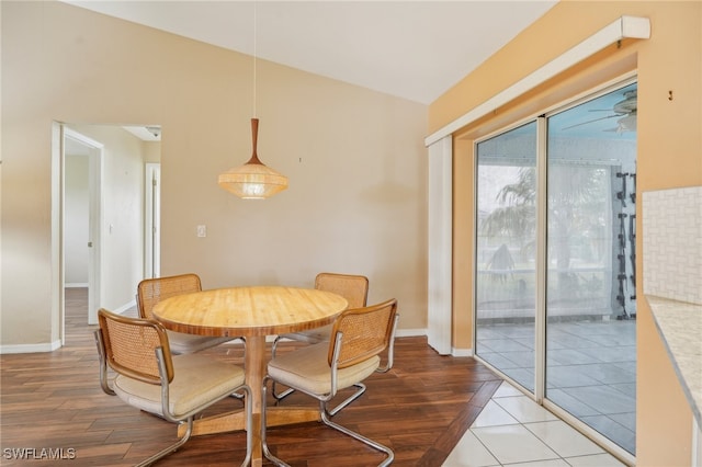 dining space with hardwood / wood-style flooring and vaulted ceiling