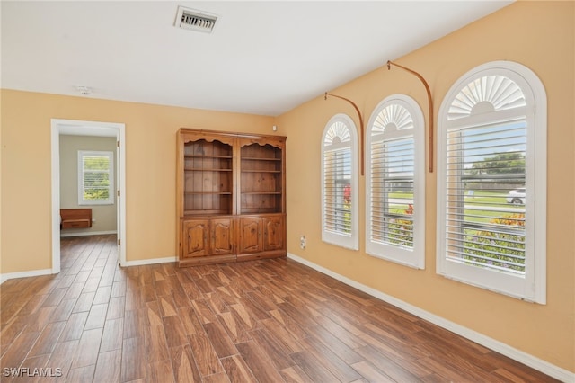 unfurnished living room featuring a healthy amount of sunlight and wood-type flooring