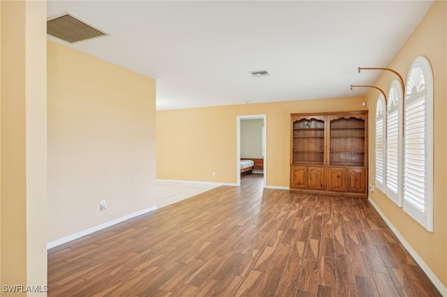 unfurnished living room featuring hardwood / wood-style flooring