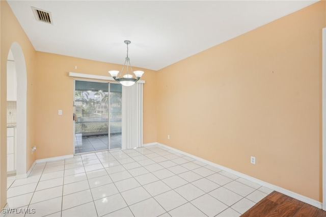 unfurnished room featuring light tile patterned floors and an inviting chandelier