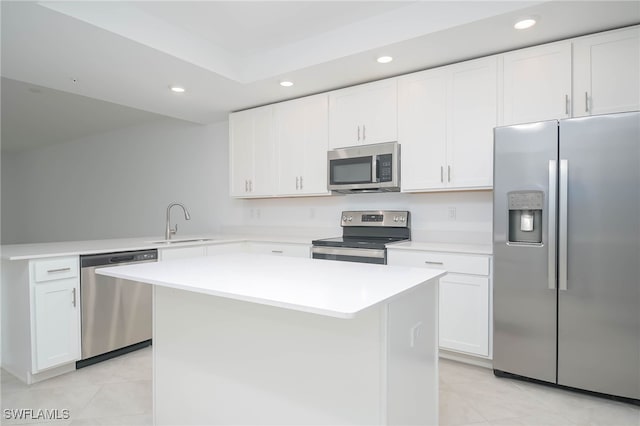 kitchen with sink, stainless steel appliances, white cabinetry, and light tile patterned floors