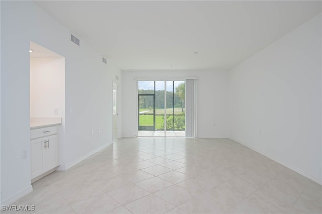 unfurnished room featuring light tile patterned floors