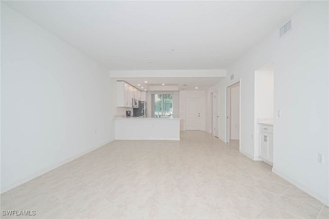 unfurnished living room with light tile patterned floors