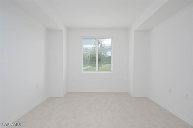 unfurnished room with light tile patterned flooring