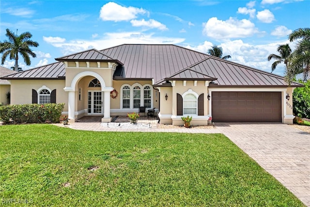 view of front of property with stucco siding, a garage, a standing seam roof, decorative driveway, and metal roof