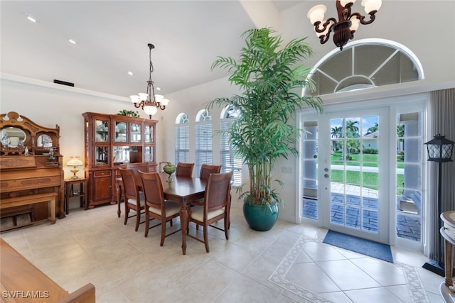 tiled dining room featuring plenty of natural light and an inviting chandelier