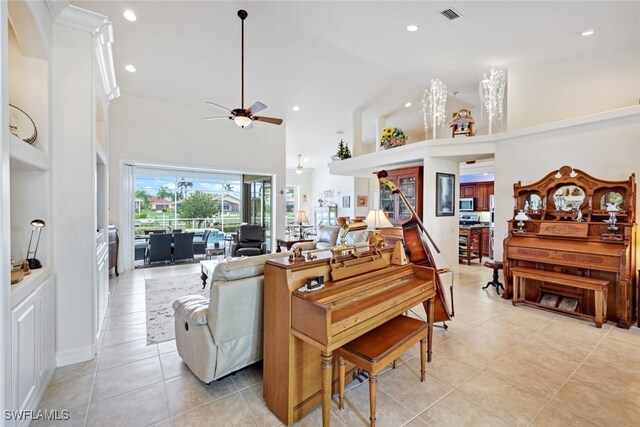 living room with high vaulted ceiling, light tile patterned flooring, and ceiling fan