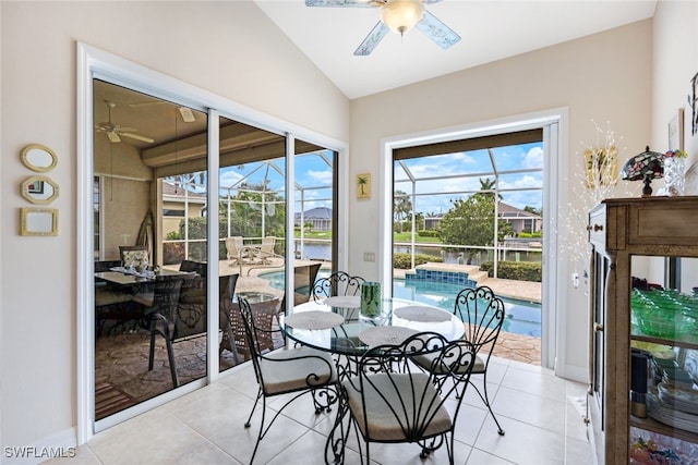 sunroom featuring lofted ceiling and a ceiling fan