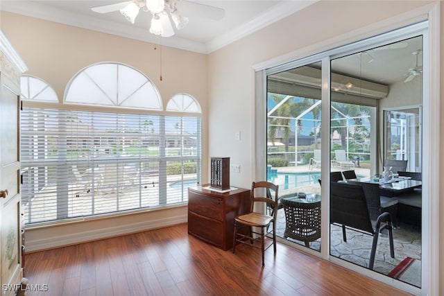 office area with ornamental molding, ceiling fan, and wood finished floors