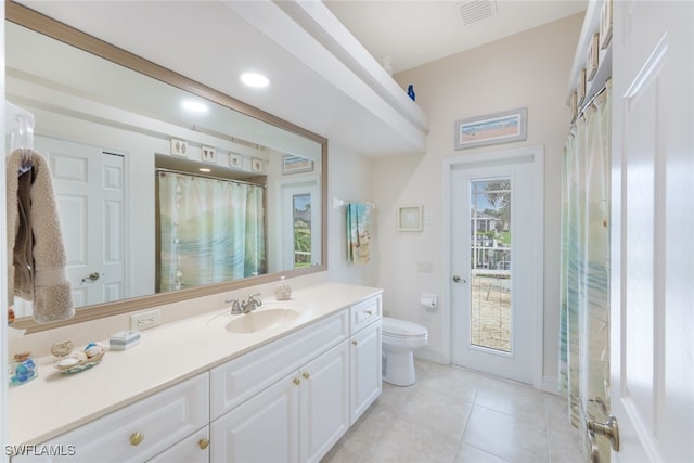 bathroom with tile patterned floors, walk in shower, toilet, and vanity