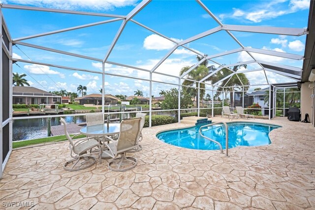 view of swimming pool with a water view, a patio, and a lanai