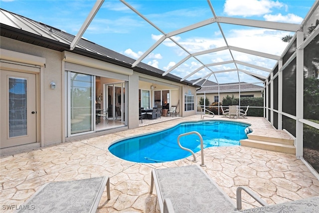 view of pool featuring a patio area and glass enclosure