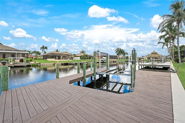 view of dock featuring boat lift, a residential view, and a water view