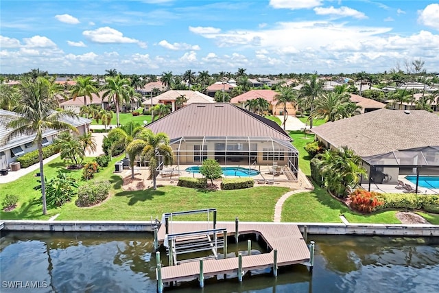 dock area featuring an outdoor pool, a water view, boat lift, a lanai, and a lawn