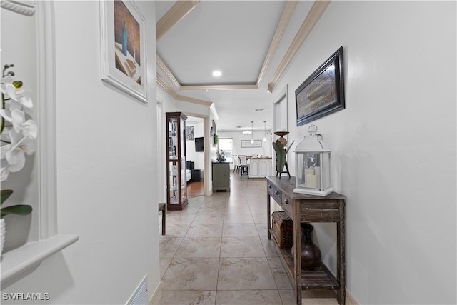 hallway featuring a raised ceiling and light tile patterned floors