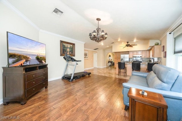 living room with crown molding, lofted ceiling, and light wood-type flooring