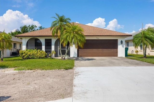 ranch-style home with central AC, a garage, and a front lawn