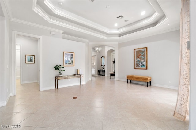 interior space featuring a raised ceiling, light tile patterned flooring, and ornamental molding