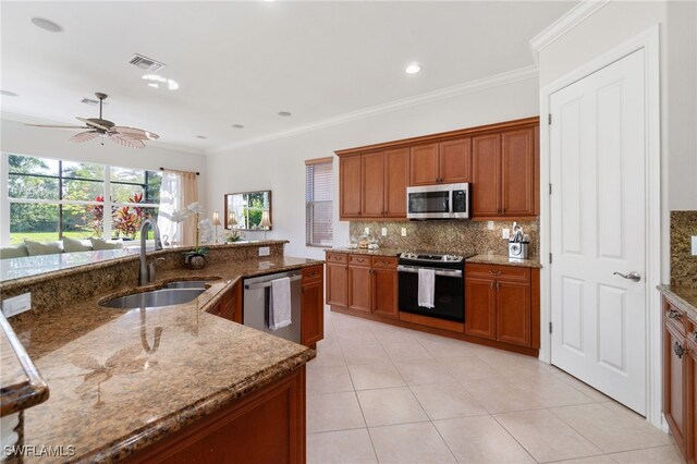 kitchen featuring ornamental molding, stainless steel appliances, sink, and stone countertops