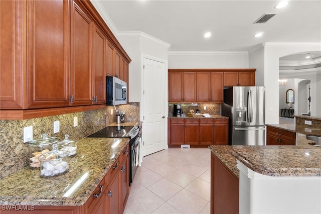 kitchen with tasteful backsplash, stone counters, stainless steel appliances, light tile patterned floors, and crown molding