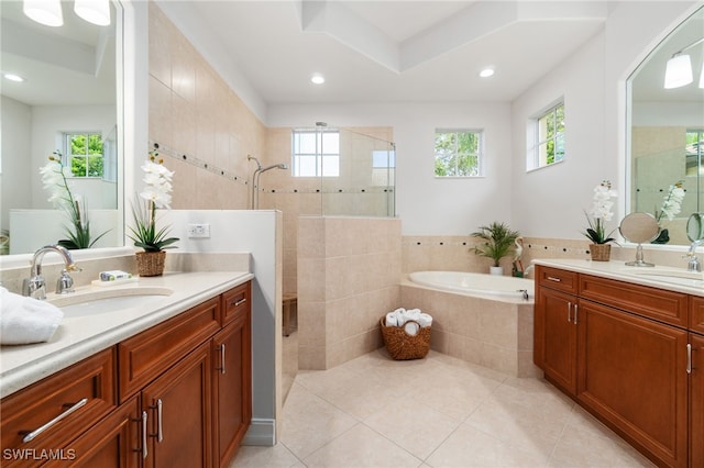 bathroom with tile patterned flooring, vanity, and separate shower and tub