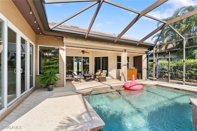 view of pool featuring ceiling fan, glass enclosure, and a patio area