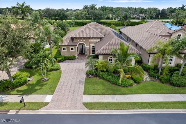 mediterranean / spanish house featuring a front lawn