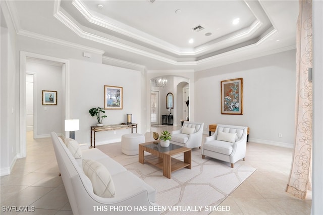 tiled living room with a tray ceiling and crown molding