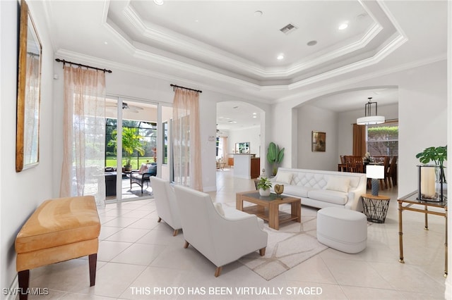 living room featuring ornamental molding, ceiling fan, a raised ceiling, and light tile patterned flooring