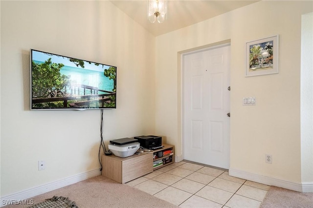 entrance foyer with vaulted ceiling and light tile patterned floors