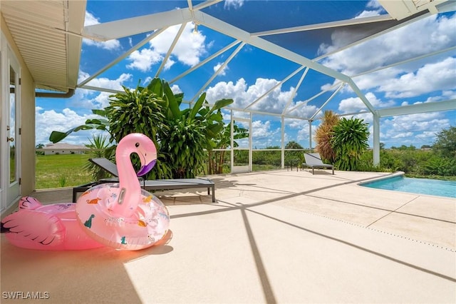 view of pool with a patio and glass enclosure