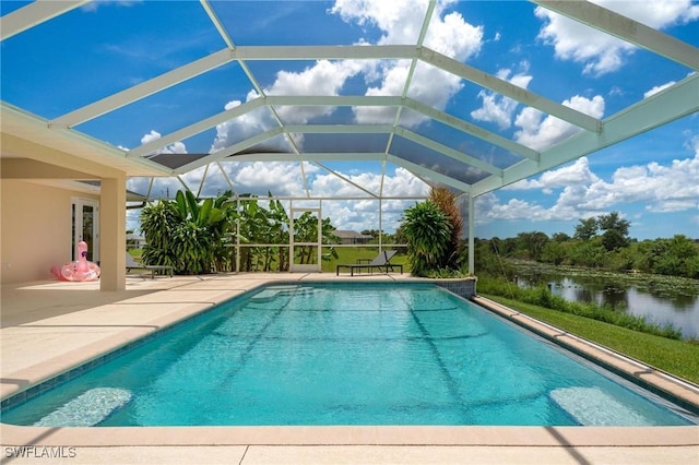 view of swimming pool featuring a patio, a water view, and a lanai