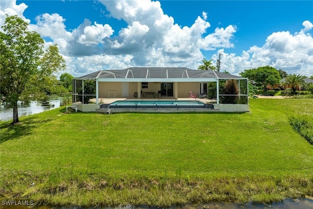 rear view of property with a water view, a lanai, and a lawn