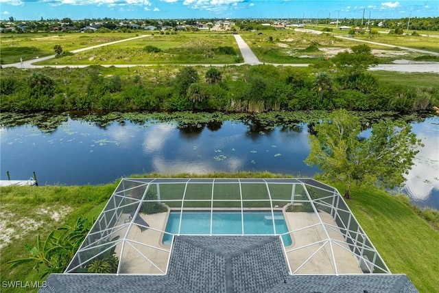 view of swimming pool featuring a water view and glass enclosure