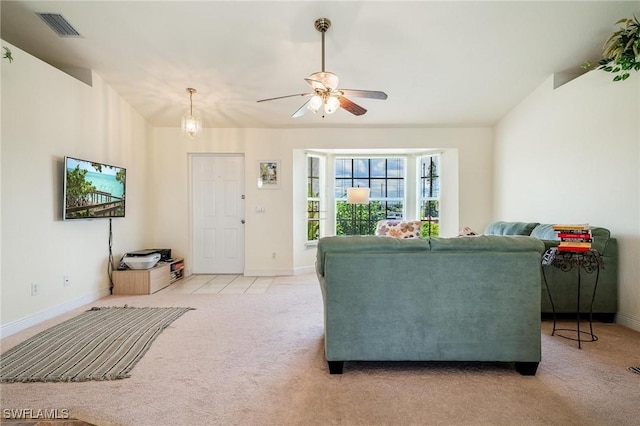 carpeted living room with lofted ceiling and ceiling fan