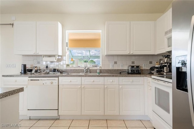 kitchen with white appliances, sink, decorative backsplash, and white cabinets